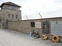 2019 - Feierlichkeiten zur 74. Wiederkehr der Befreiung des Konzentrationslagers Mauthausen, durch amerikanische Truppen  2019 - Feierlichkeiten zur 74. Wiederkehr der Befreiung des Konzentrationslagers Mauthausen, durch amerikanische Truppen. Dieses Bild zeigt eine Galerie mit Gedenktafeln an der Innenwand der Aussenmauer des Lagers. Unter den Gedenktafeln sind Blumengrüße zum Gedenktag abgelegt. Im Hintergrund ist einer der Wachtürme des Lagers zu sehen. : #1B#4, 74. Befreiungsfeier, 74. Gedenkfeier, Aussenmauer, Außenmauer, Befreiungsfeier, Blumenkraenze, Blumenkranz, Blumenkränze, Blumenschmuck, Galerie, Gedenkfeier, Gedenktafeln, Geschichte, Innenseite, KZ, Konzentrationslager, Mauthausen, Steinmauern, Wachturm, historisch